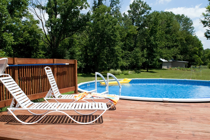 above-ground pool with deck and chairs
