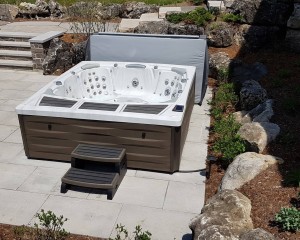 Kingston hot tub from Sundance Spas installed in a backyard space.