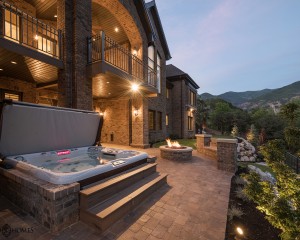 Hot tub outside beautiful mansion.