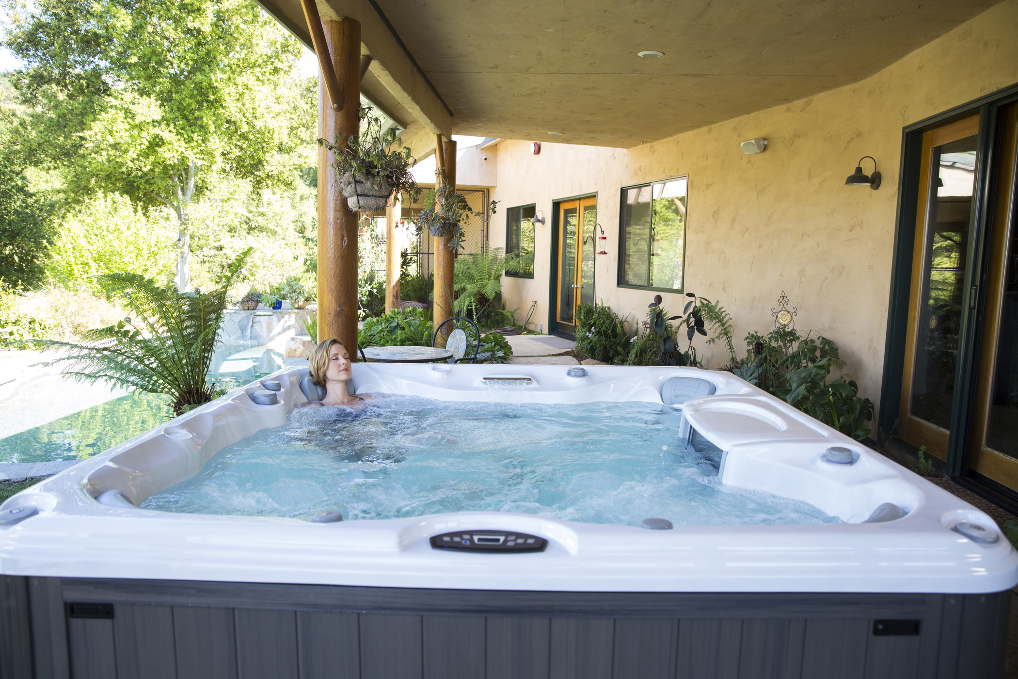 Woman soaking in a Sundance Spas hot tub.