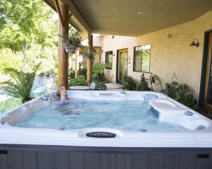 Woman soaking in a Sundance Spas hot tub.